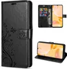 A collage of images showing a black leather flip phone case with a floral design, including a view of the inside with card slots and a phone in a stand position. Produktbild-Vorschau