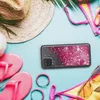 A flat lay of summer accessories including a straw hat, sunglasses, flip-flops, a bikini, and a phone case with glitter. Produktbild-Vorschau