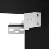 A close-up view of a white metal bracket attached to a dark wood surface, likely part of a TV cabinet assembly. Produktbild-Vorschau