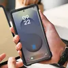 A person is holding a smartphone with a protective case. Produktbild-Vorschau