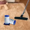 Two vacuum cleaner filters are placed on a fluffy carpet next to a vacuum cleaner head and a teddy bear. Produktbild-Vorschau