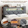A bed with a grey upholstered headboard featuring built-in storage and lighting, shown with pillows and bedding. Podgląd zdjęcia produktu