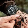 A close-up shot of a person's wrist wearing a CASIO G-SHOCK MUDMASTER watch, covered in dirt and mud. Podgląd zdjęcia produktu