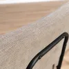 Close-up of the textured fabric of a bar stool with a black metal frame. Produktbild-Vorschau