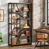 A tall, multi-shelf bookshelf filled with decorative items and books, placed in a room with a brick wall and a desk. Voir les images du produit