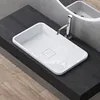 A modern bathroom sink setup with a white rectangular basin, a chrome faucet, and a dark wood countertop. Anteprima dell’immagine prodotto