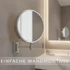 A bathroom setting with a wall-mounted magnifying mirror. Produktbild-Vorschau