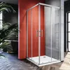 A modern bathroom with a red accent wall and a glass shower enclosure. Voir les images du produit