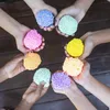 A group of children's hands holding colorful balls of Playfoam. Produktbild-Vorschau