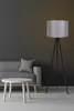 A modern living room scene with a sofa, coffee table, and a floor lamp. Produktbild-Vorschau