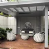 An outdoor seating area with a sofa, two armchairs, and a coffee table. Produktbild-Vorschau