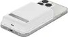 A white Belkin power bank is attached to the back of a silver smartphone. Voir les images du produit