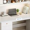 A white desk with a laptop, a small robot figure, a plant, a mug, and books. Produktbild-Vorschau