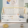 A children's house bed with a pull-out drawer, decorated with string lights, in a room setting. Produktbild-Vorschau