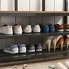A shoe rack with multiple pairs of shoes on different shelves. Podgląd zdjęcia produktu