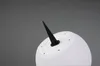 A close-up shot of the base of a white, egg-shaped outdoor lamp with a black spike for ground insertion. Produktbild-Vorschau