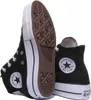 A pair of black Converse high-top sneakers shown from a diagonal angle, with one shoe standing upright and the other lying on its side, revealing the sole. Voir les images du produit