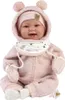 A baby doll dressed in a pink outfit with a hood and pom-poms, sitting on a white background. Podgląd zdjęcia produktu