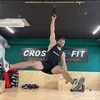 A man is performing an exercise using a TRX-like suspension trainer in a gym. Náhled obrázku produktu