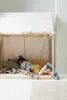 A child is lying on a bed inside a play tent. Produktbild-Vorschau