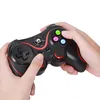 Hands holding a black game controller with red accents and colored buttons. Produktbild-Vorschau