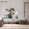 A living room scene with a sofa, coffee table, and plants. Produktbild-Vorschau