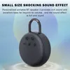 A dark gray portable Bluetooth speaker with a handle is shown against a soft, gradient background with abstract circular shapes. Produktbild-Vorschau