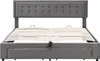 A grey upholstered bed frame with a tufted headboard and a slatted mattress support system is shown from the front. Produktbild-Vorschau