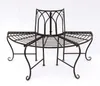 A metal garden bench with a curved seat and a decorative backrest, shown against a white background. Náhled obrázku produktu