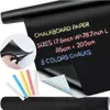 A roll of black chalkboard paper with chalk sticks and scissors. Produktbild-Vorschau