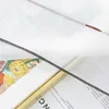 A close-up view of a fabric with a floral pattern, showing stitching and text from a book or magazine in the background. Produktbild-Vorschau