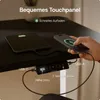 A close-up view of a desk with a tablet and smartphone charging, and a control panel for a height-adjustable desk. Voir les images du produit