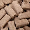 A close-up, overhead view of many brown, cylindrical mineral bricks. Anteprima dell’immagine prodotto