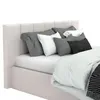 A close-up view of a bed with multiple pillows and bedding. Produktbild-Vorschau