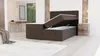 A bedroom scene featuring an open storage bed with a mattress and topper. Produktbild-Vorschau