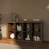A modern living room with a wooden bookshelf filled with decorative items and books. Produktbild-Vorschau
