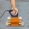 A hand holding a concrete vibrator over a concrete surface. Podgląd zdjęcia produktu