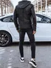 A person wearing a black leather jacket and black jeans stands next to a white car. Voir les images du produit