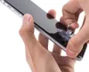Hands are using a suction cup tool to lift the screen of a smartphone. Produktbild-Vorschau