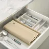 A kitchen drawer with a beige drying mat and cutlery organizer filled with silverware. Náhľad obrázku produktu