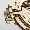 A close-up view of a wooden 3D puzzle, specifically a perpetual calendar, showing intricate details of its layered construction and engraved markings. Anteprima dell’immagine prodotto