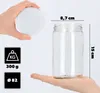 A hand holds a white lid above a clear glass jar, with measurement indicators and weight/diameter icons to the left. Podgląd zdjęcia produktu