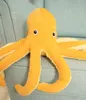 A plush octopus toy is placed on a light blue chair. Anteprima dell’immagine prodotto