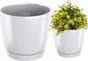 Two white plant pots are shown, one empty and one with a green plant with pink flowers. Produktbild-Vorschau