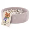 A pink corduroy ball pit filled with gold and white balls, with a tag attached. Náhľad obrázku produktu