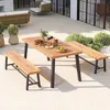 An outdoor patio scene with a wooden dining table and benches, surrounded by greenery and modern outdoor furniture. Anteprima dell’immagine prodotto