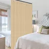 A bedroom with two beds, divided by a beige curtain. Náhled obrázku produktu