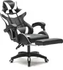 A black and white gaming chair with a footrest is shown against a white background.