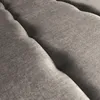 A close-up view of the textured fabric of a tufted sofa. Produktbild-Vorschau