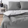 A close-up view of a gray duvet cover and pillowcase set. Produktbild-Vorschau